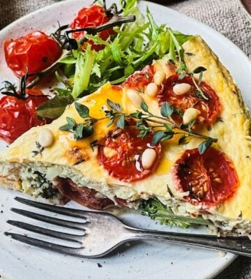 A vegan cheese and tomato quiche made with dairy-free ingredients