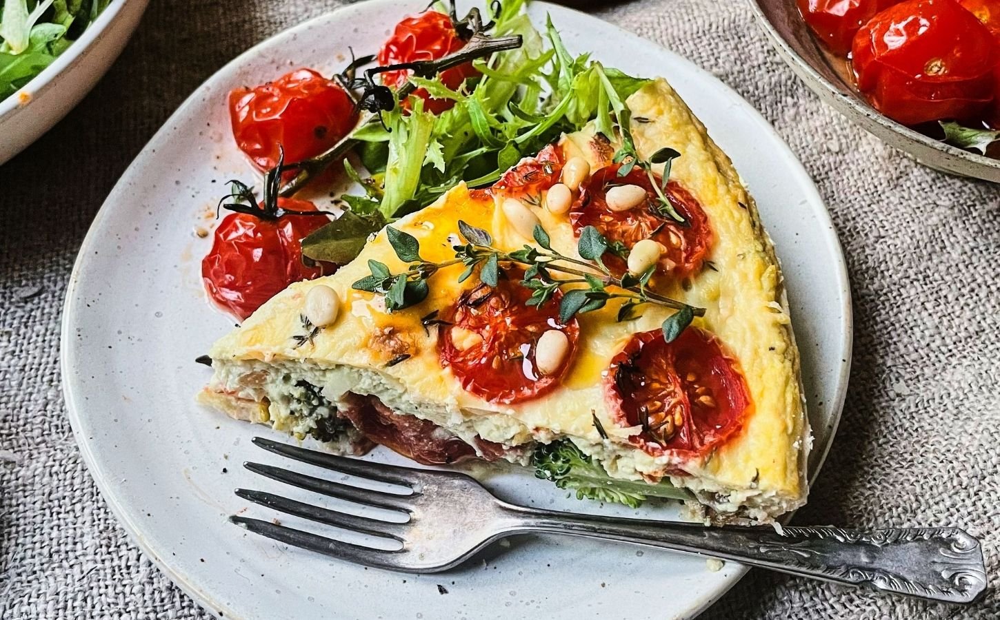 A vegan cheese and tomato quiche made with dairy-free ingredients