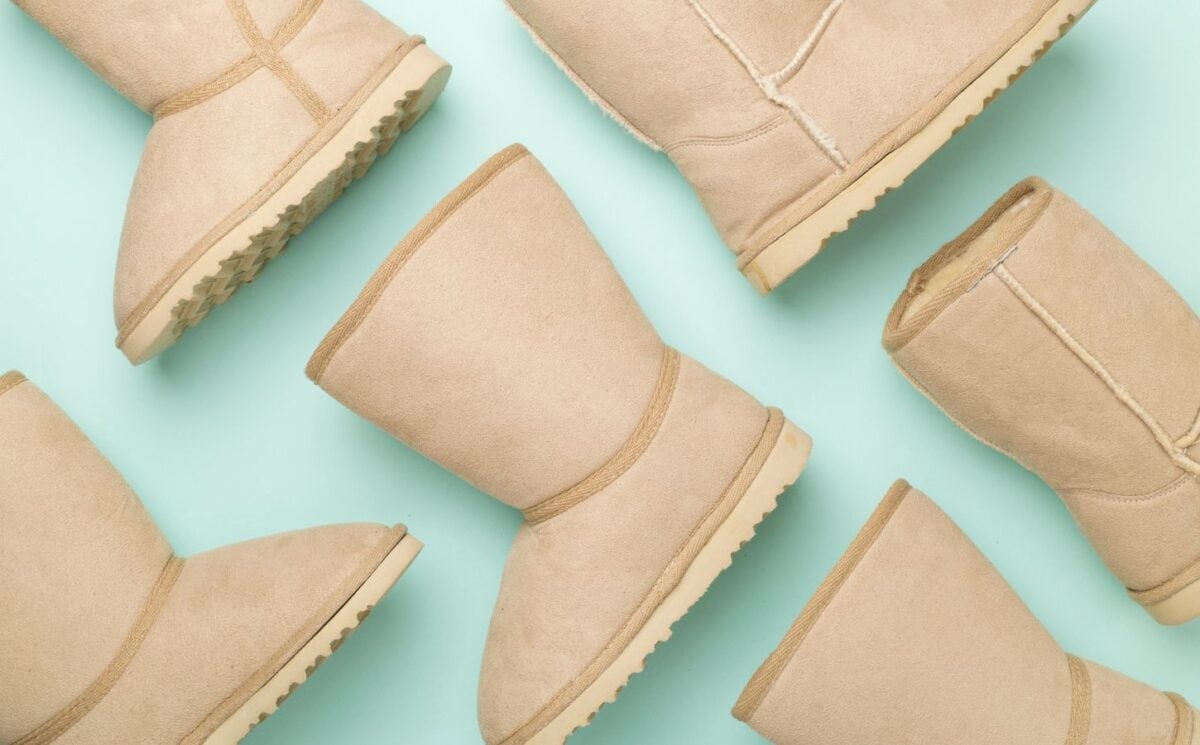 Ugg boots, which are not vegan-friendly, before a pale green background