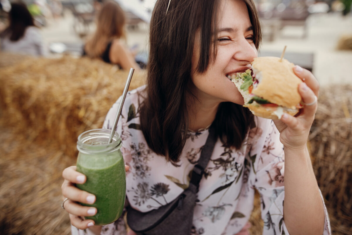 A woman eating a vegan burger