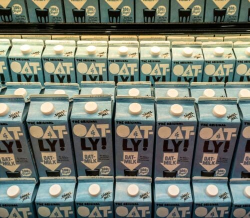 Lines of Oatly bottles, which will now be able to feature the slogan 'Post Milk Generation'