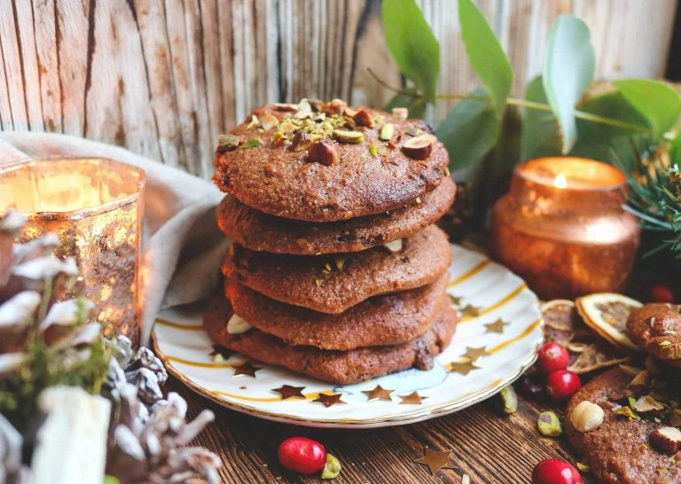 Photo shows a stack of spiced orange Christmas cookies on a small white plate.