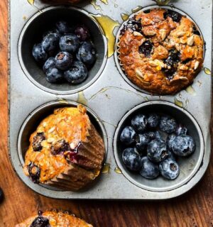 A tray of freshly cooked vegan breakfast muffins with blueberries