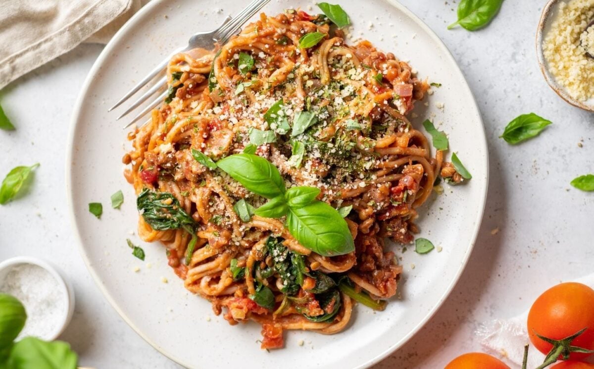 Photo shows a large plate of spaghetti with tomato sauce prepared using a vegan recipe.