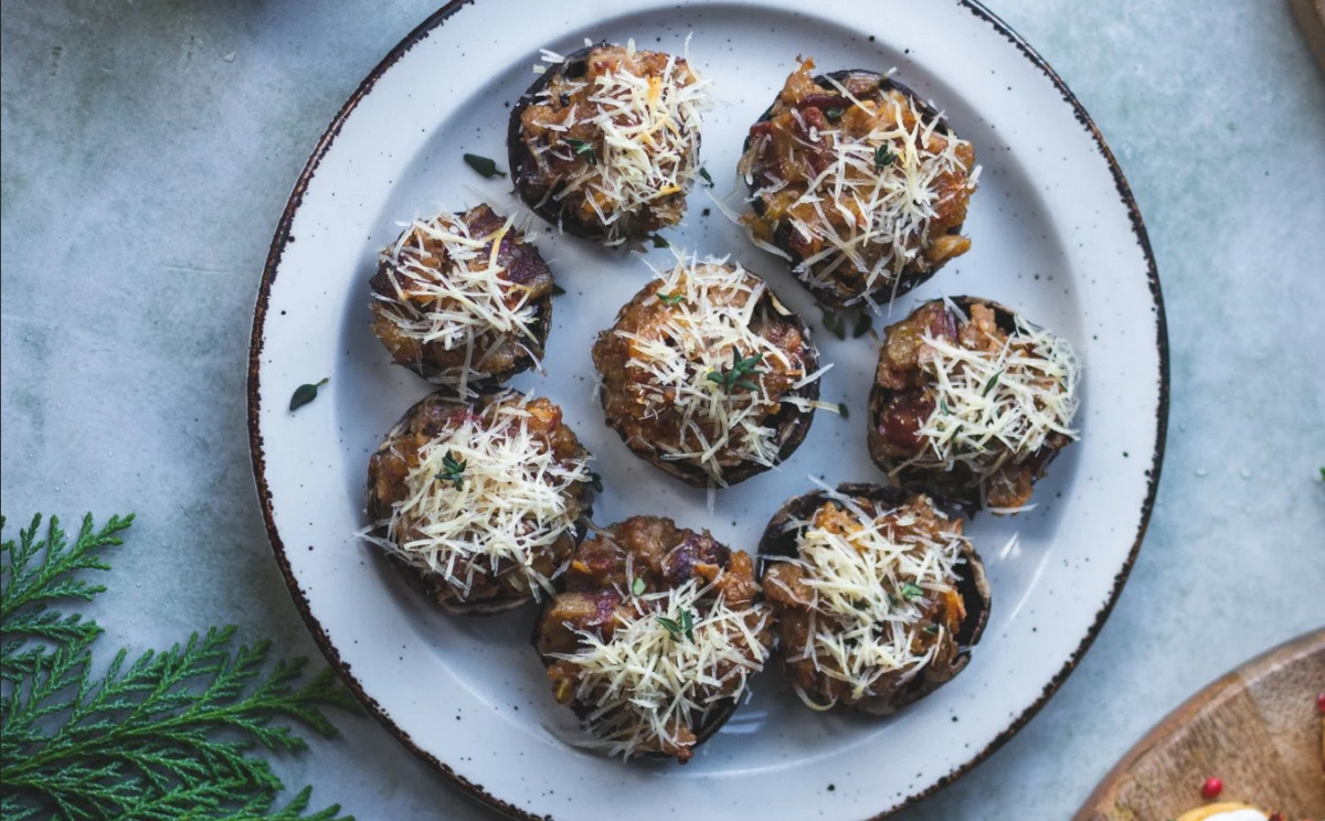 Photo shows a plate of stuffed mushrooms.