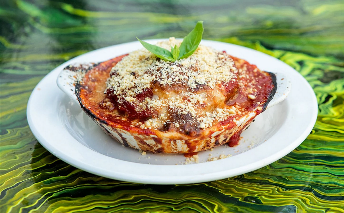 Photo shows a bowl of parmigiana prepared using a vegan recipe.