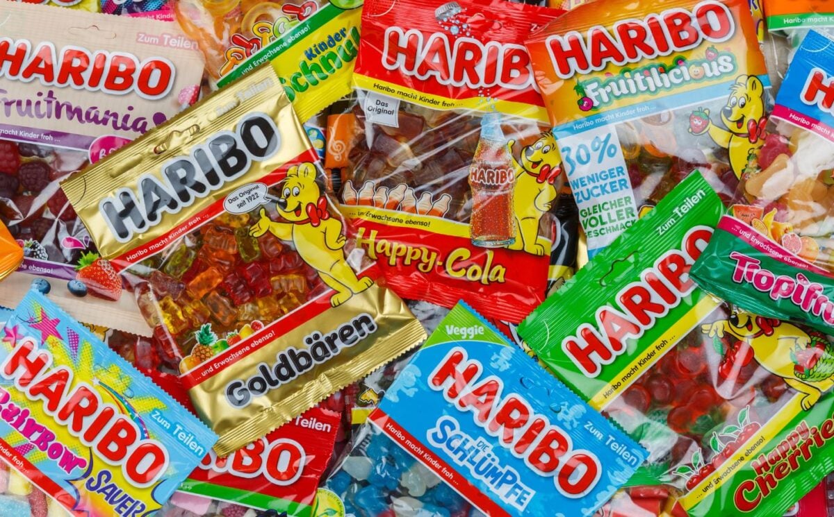 Photo shows a piled selection of famous Haribo sweet wrappers layered on top of one another.