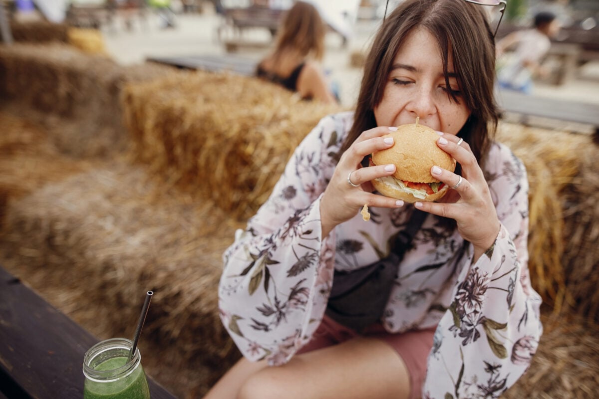 Woman bites into a vegan burger