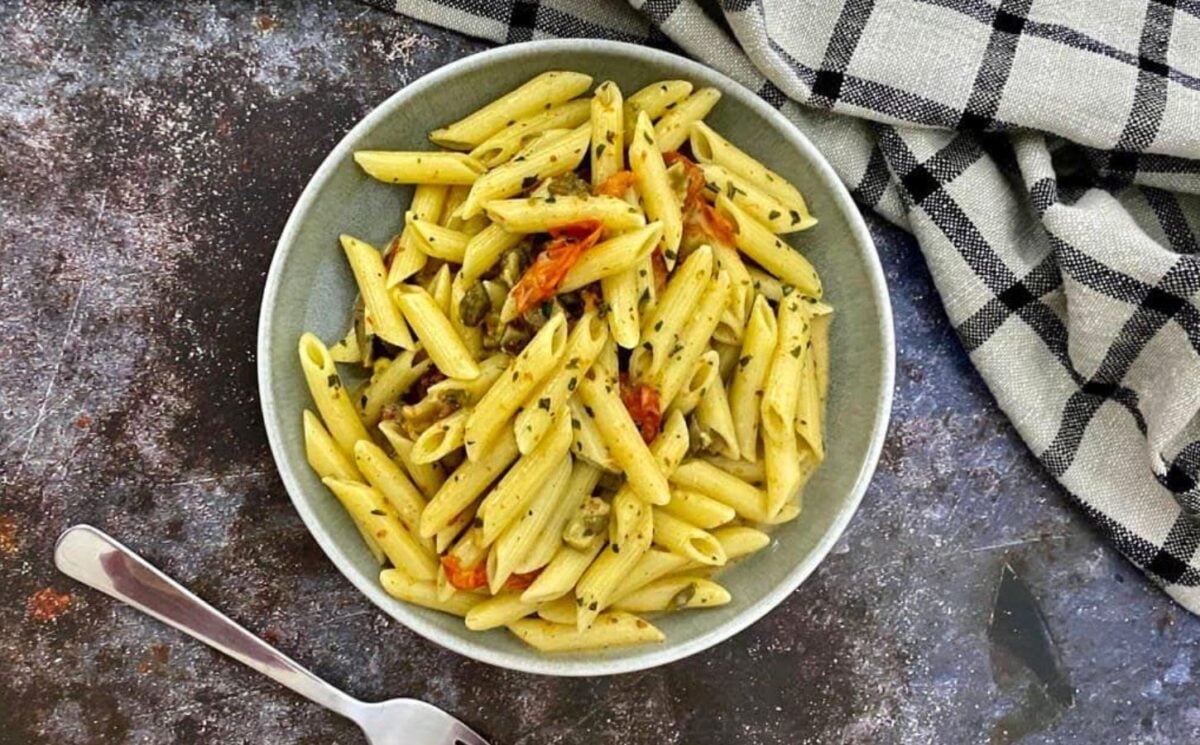 Photo shows a bowl of vegan baked feta pasta.