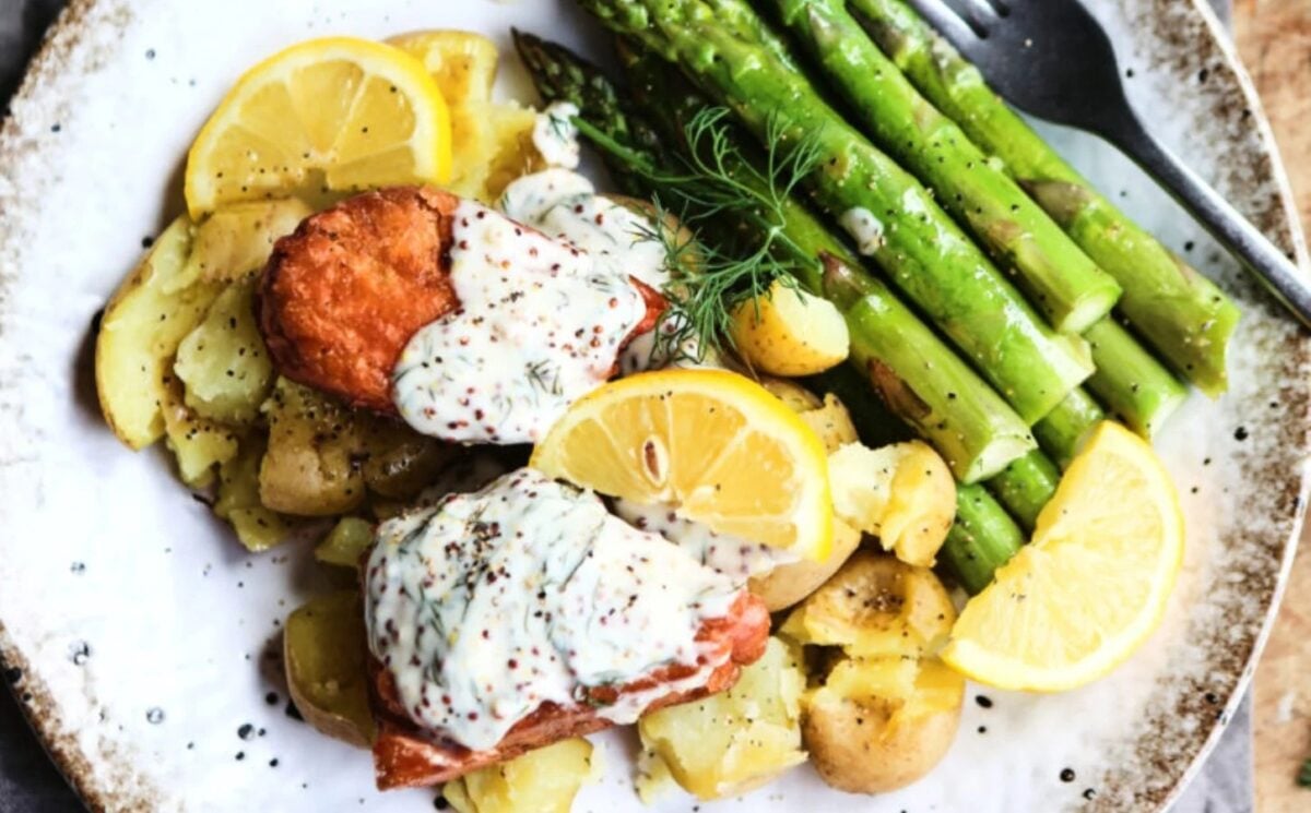 Photo shows a plate of vegan salmon topped with a creamy dill sauce.