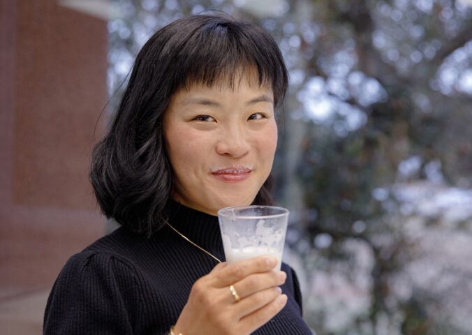 TurtleTree CEO and Co-Founder Fengru Lin holds a glass of the world's first vegan-certified lactoferrin, LF+