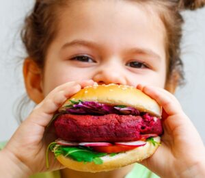 A girl eating a vegan burger