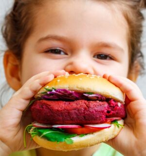 A girl eating a vegan burger