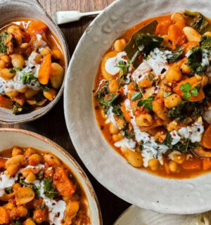 Photo shows three dishes of stew made with beans, kale, and lemon