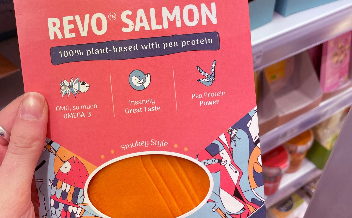 Photo shows someone holding a package of plant-based 'Revo Salmon' in the supermarket.