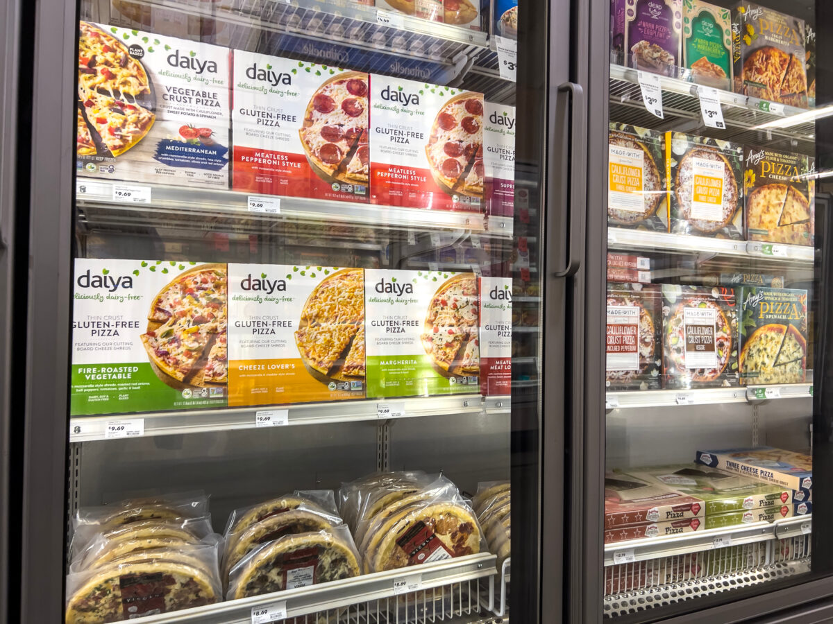 A supermarket fridge containing dairy-free pizzas