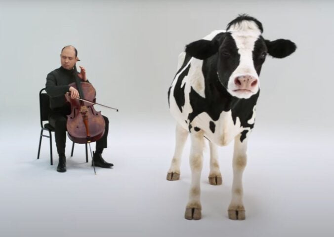 A still showing a cartoon cow and a man playing the violin, taken from an anti-dairy advert from Flora