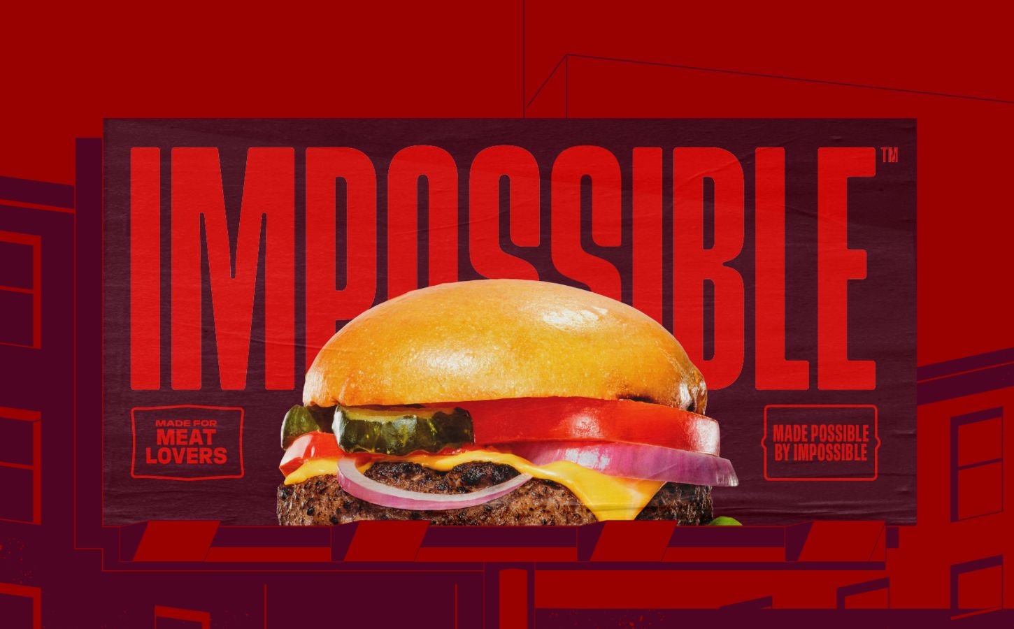 Photo shows a burger made with an Impossible Foods patty in a dark red background with the company logo on it - part of a new brand-wide redesign