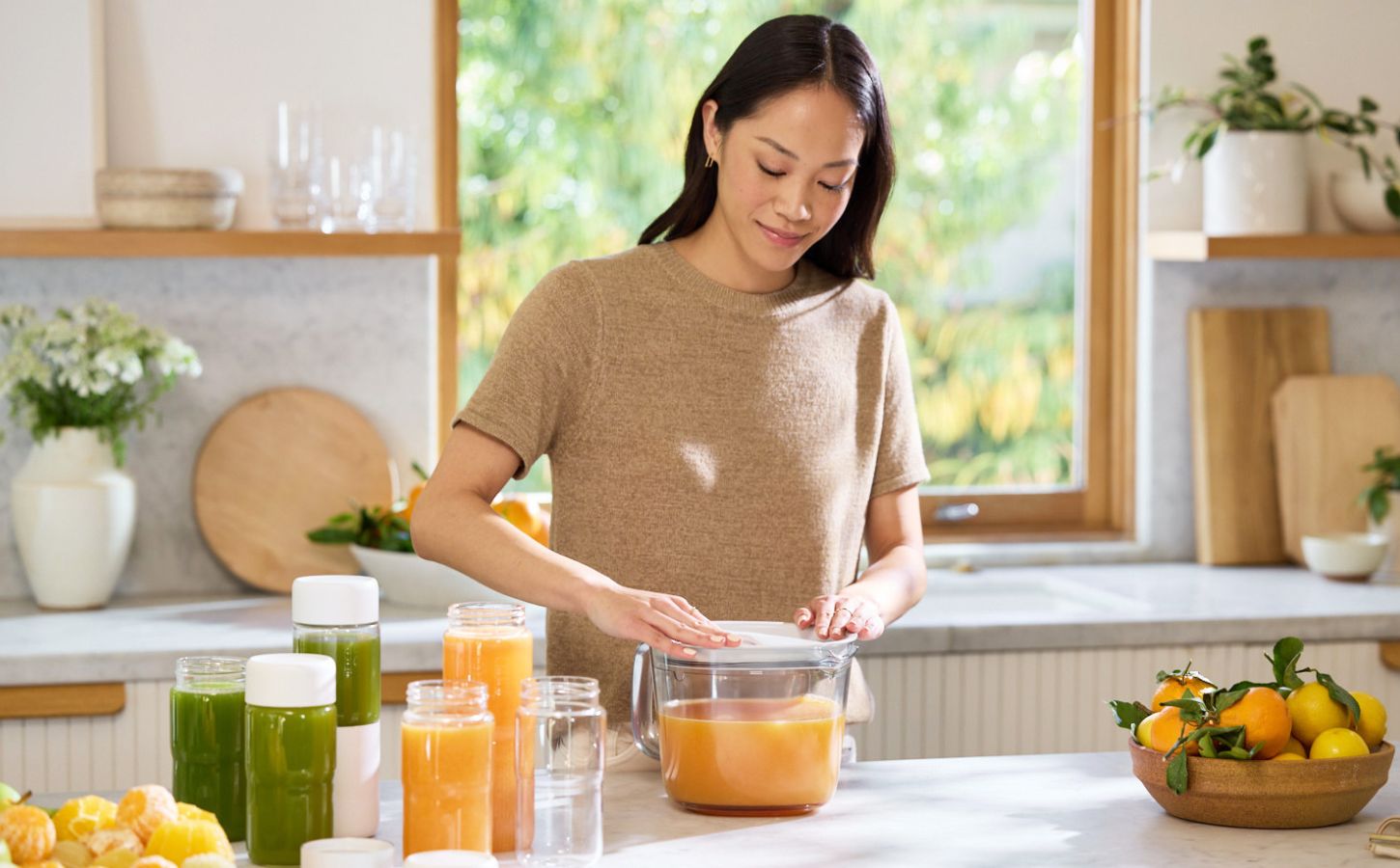A woman using her NAMA juicer to back juice
