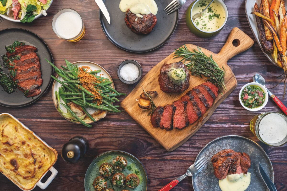 A vegan steak on a table with other plant-based dishes
