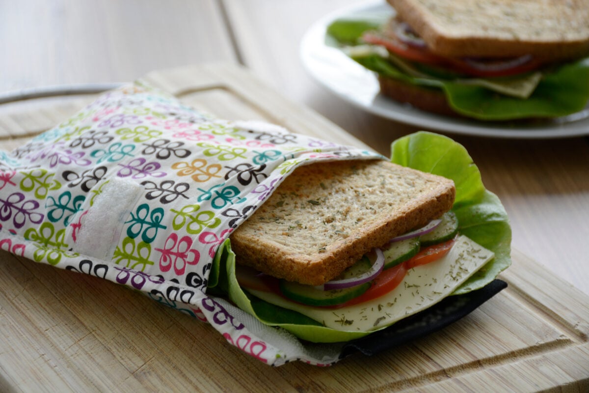Photo shows a sandwich in an environmentally-friendly reusable wrapper