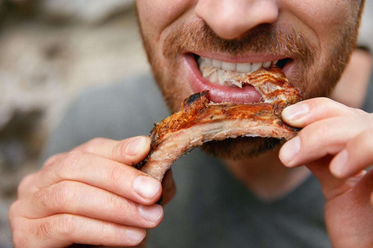 A man eating a piece of meat