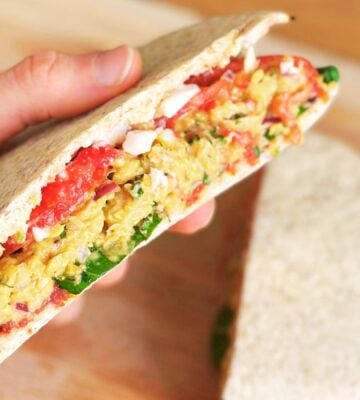 vegan chickpea sandwich plant-based pita sandwich with tomato and onion