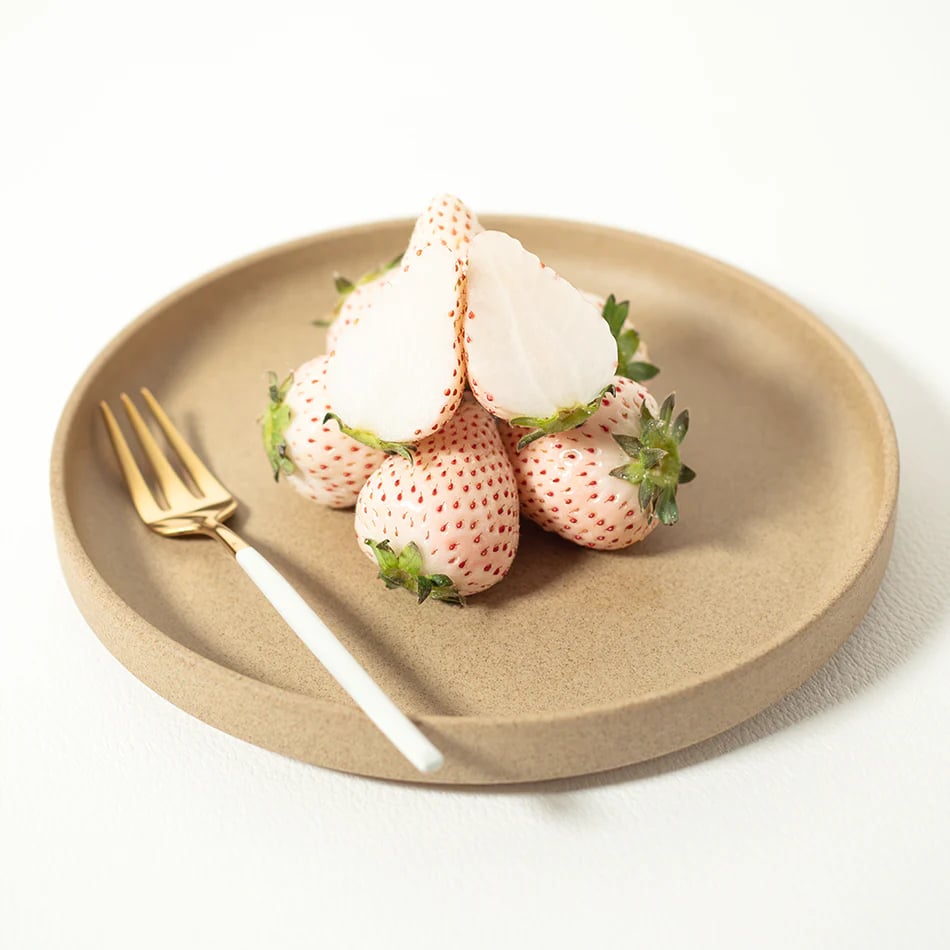 Photo shows a plate of the luxury white strawberries exported by Ikigai Fruits