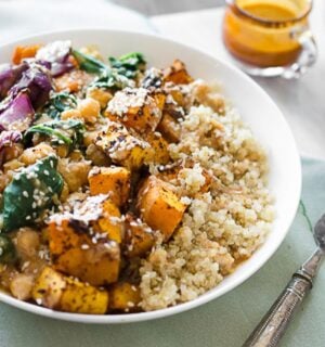 vegan roasted butternut squash and quinoa bowl made with chickpeas spinach and an almond citrus sauce