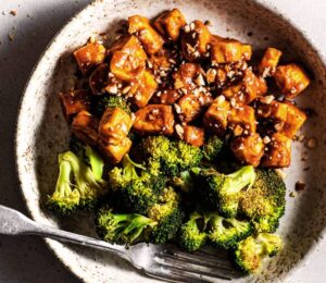Sheet pan broccoli and tofu covered in a sticky sauce roasted in one pan