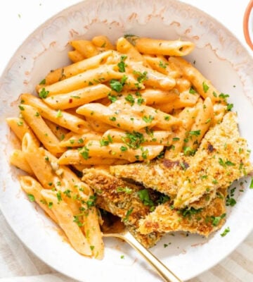 Photo shows a large white bowl of a vegan Cajun-style pasta recipe made with tempeh, a gut-friendly fermented food