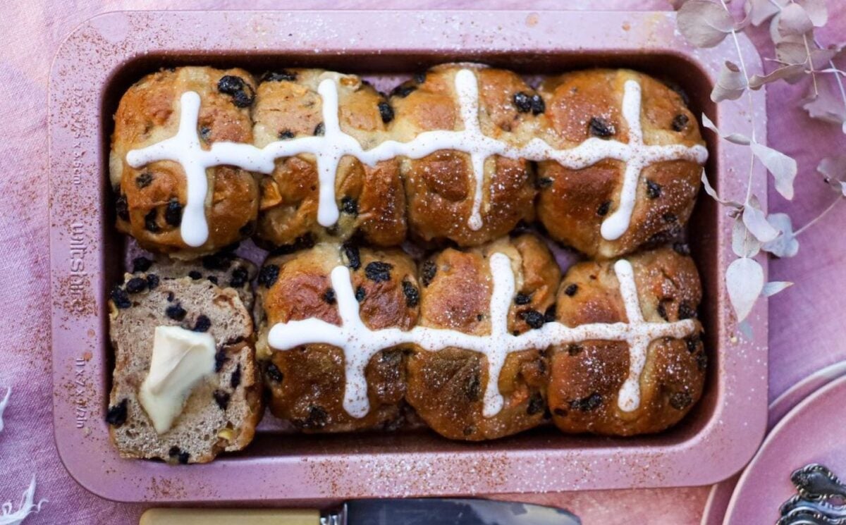 Photo shows a tray of freshly baked vegan hot cross buns