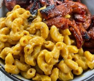 creamy vegan macaroni and plant-based cheese recipe with barbeque soy curls on the side