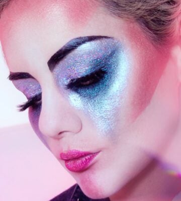 Close up shot of a woman wearing lots of brightly colored eye shadow