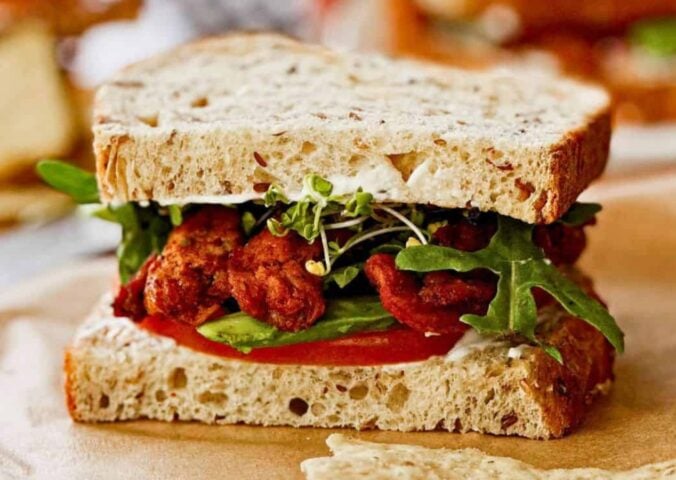 A vegan BLT sandwich made with soy curls and other plant-based ingredients