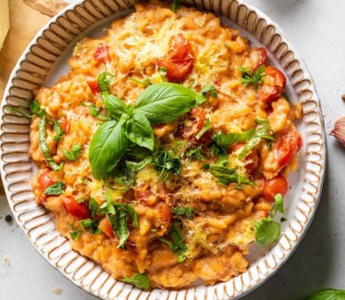 A bowl of vegan cherry tomato risotto made to a dairy-free and plant-based recipe