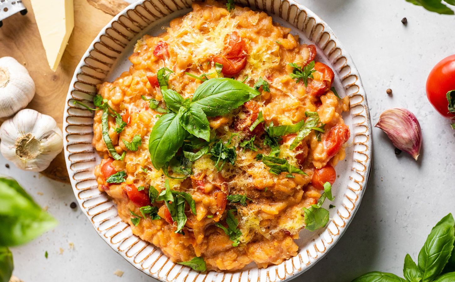 A bowl of vegan cherry tomato risotto made to a dairy-free and plant-based recipe
