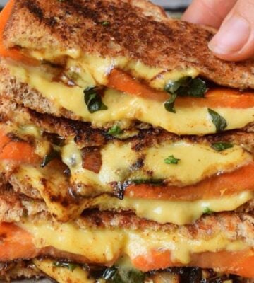 Photo shows a recipe for a vegan grilled sandwich featuring carrots and spinach as well as plant-based cheese