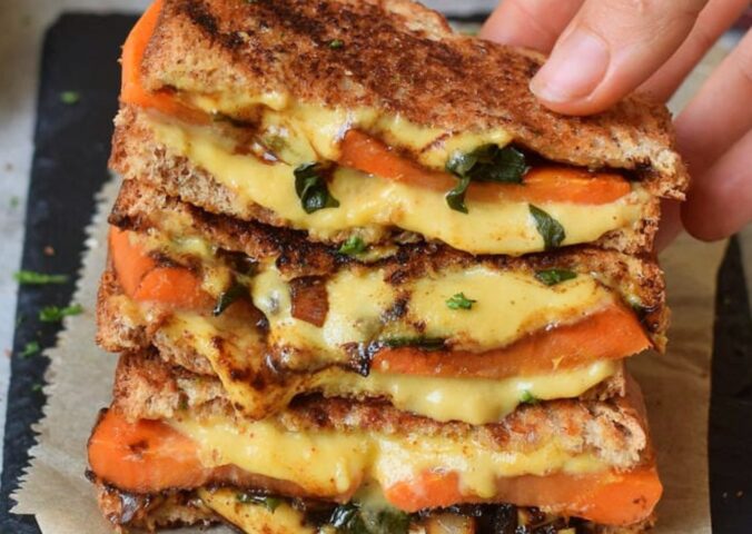 Photo shows a recipe for a vegan grilled sandwich featuring carrots and spinach as well as plant-based cheese