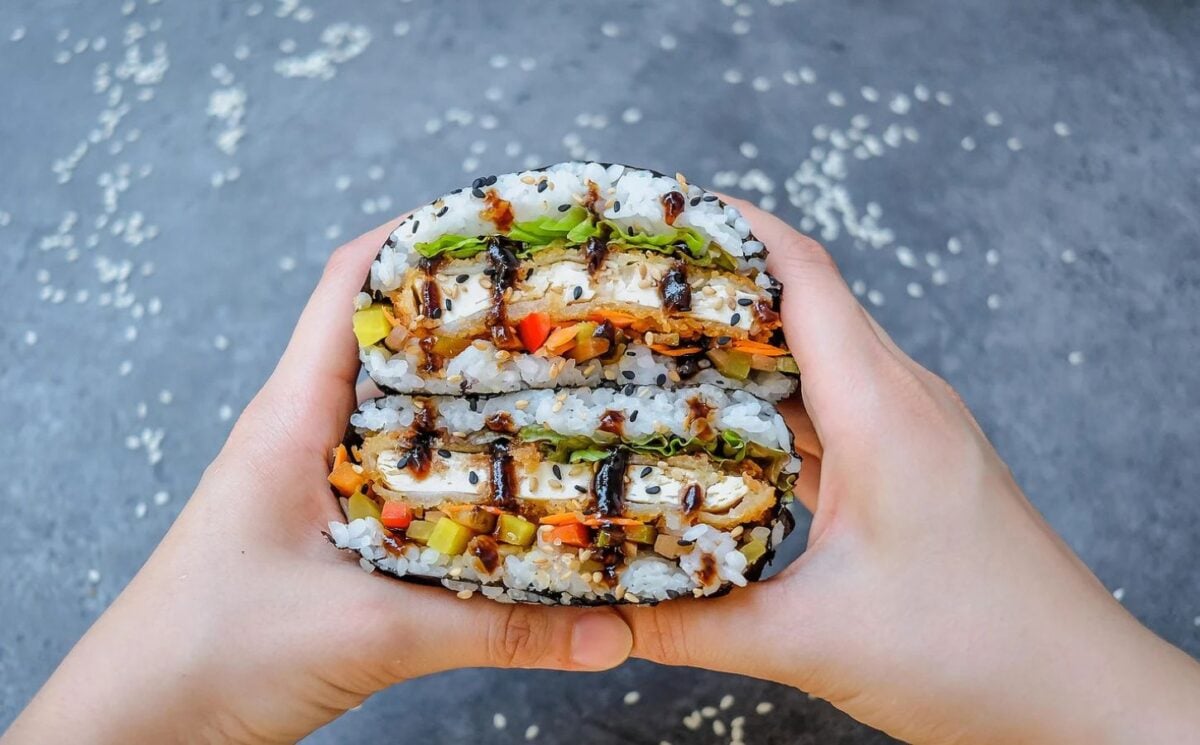 Photo shows a vegan "sandwich" made using sushi ingredients like white rice and katsu flavored tofu
