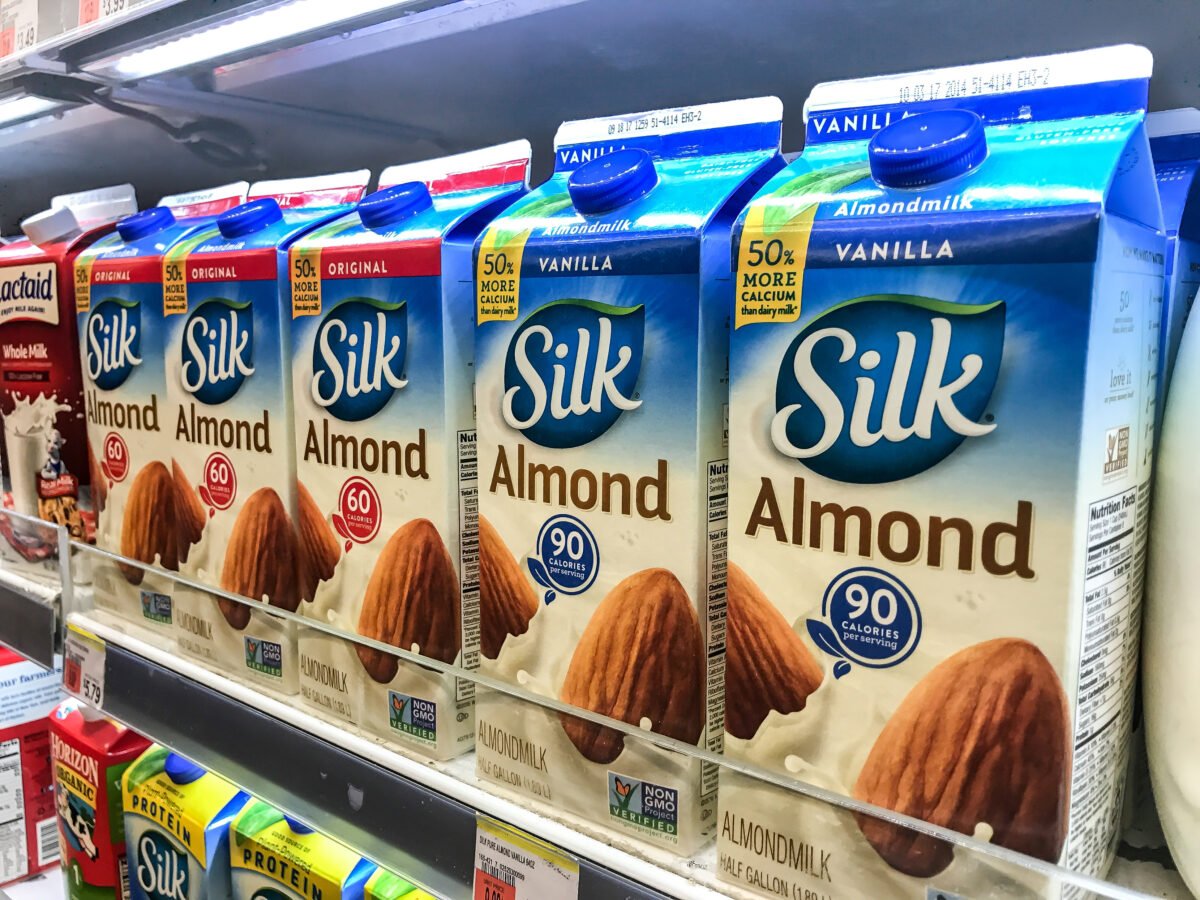 Cartons of almond milk on a supermarket shelf