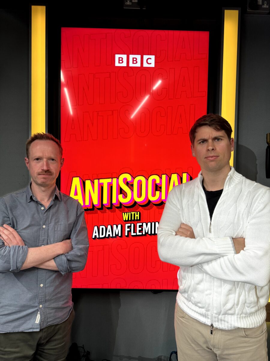 PBN founder Klaus Mitchell with Adam Fleming in front of a sign saying "AntiSocial with Adam Fleming"