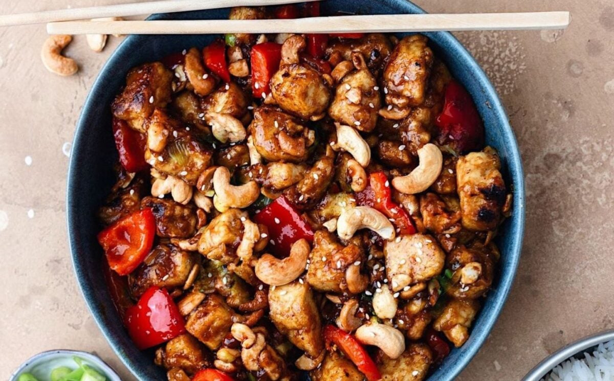 Photo shows a cashew tofu stir fry prepared to a vegan recipe and is high in plant-based protein