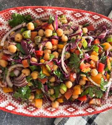 vegan, nut-free, gluten-free chickpea rainbow salad made with cucumber, cabbage, onion, bell peppers and a simple salad dressing