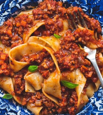 vegan classic Bolognese made with ragu-style tomato sauce and topped over pappardelle pasta