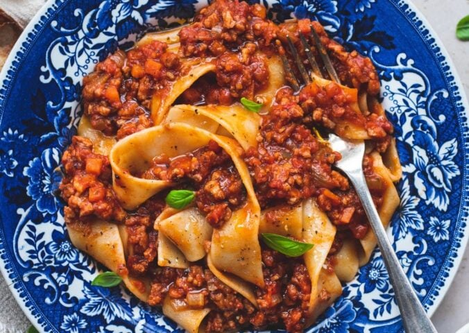 vegan classic Bolognese made with ragu-style tomato sauce and topped over pappardelle pasta