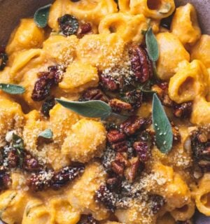 creamy pumpkin pasta made with maple sage and pecan crumble and vegan parmesan