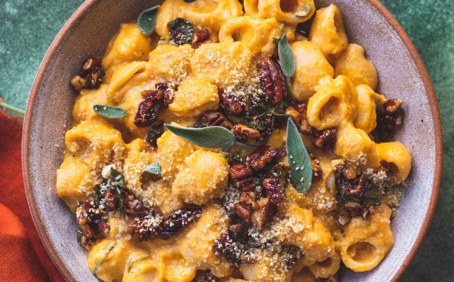 creamy pumpkin pasta made with maple sage and pecan crumble and vegan parmesan