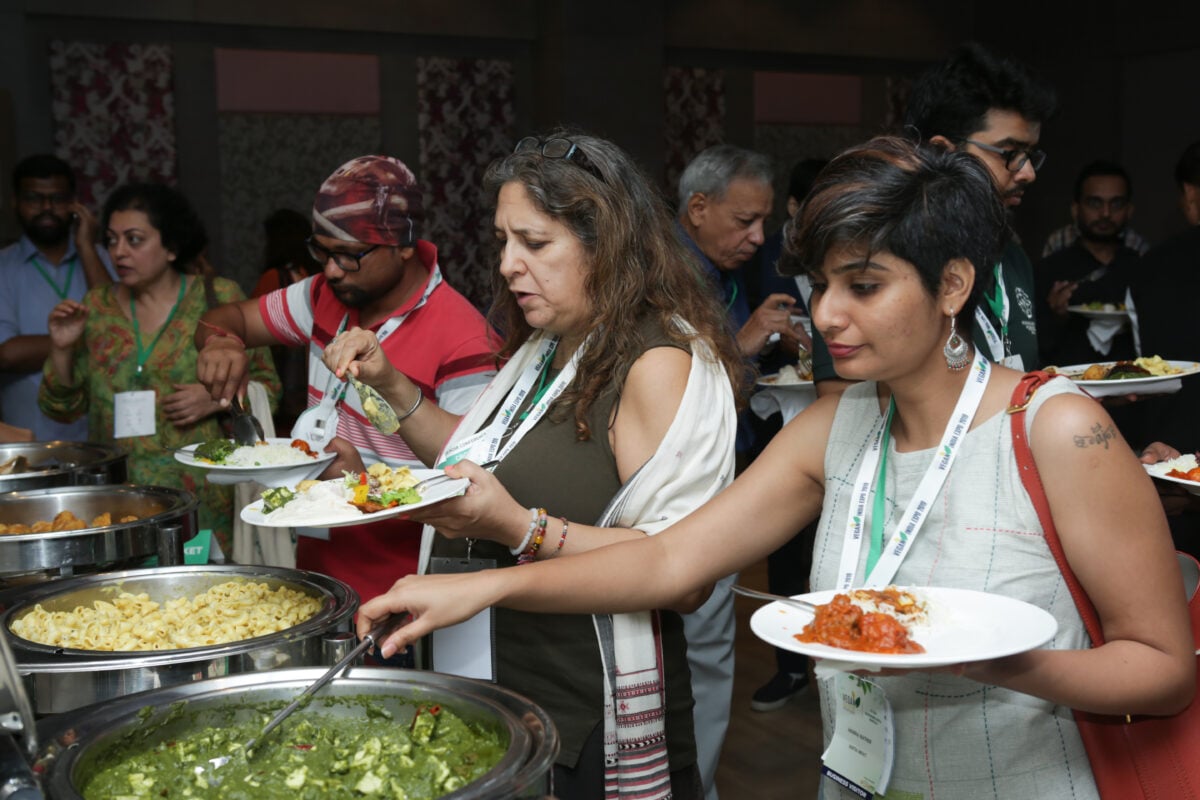 Attendees to Vegan India Conference trying plant-based food