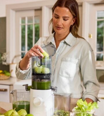 A woman making a homemade juice with a compact Nama J3 juicer